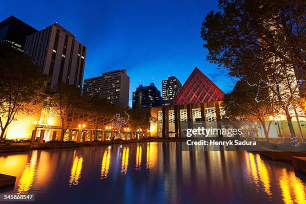 canada, alberta, edmonton, edmonton city hall by pond at dusk - edmonton cityscape stock pictures, royalty-free photos & images