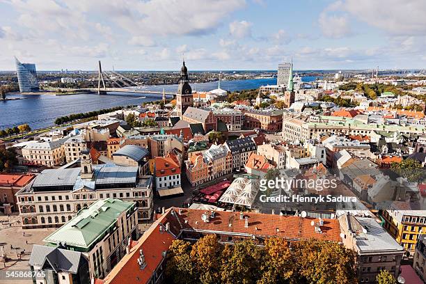 latvia, riga, cityscape of old town and river in distance - riga stock pictures, royalty-free photos & images