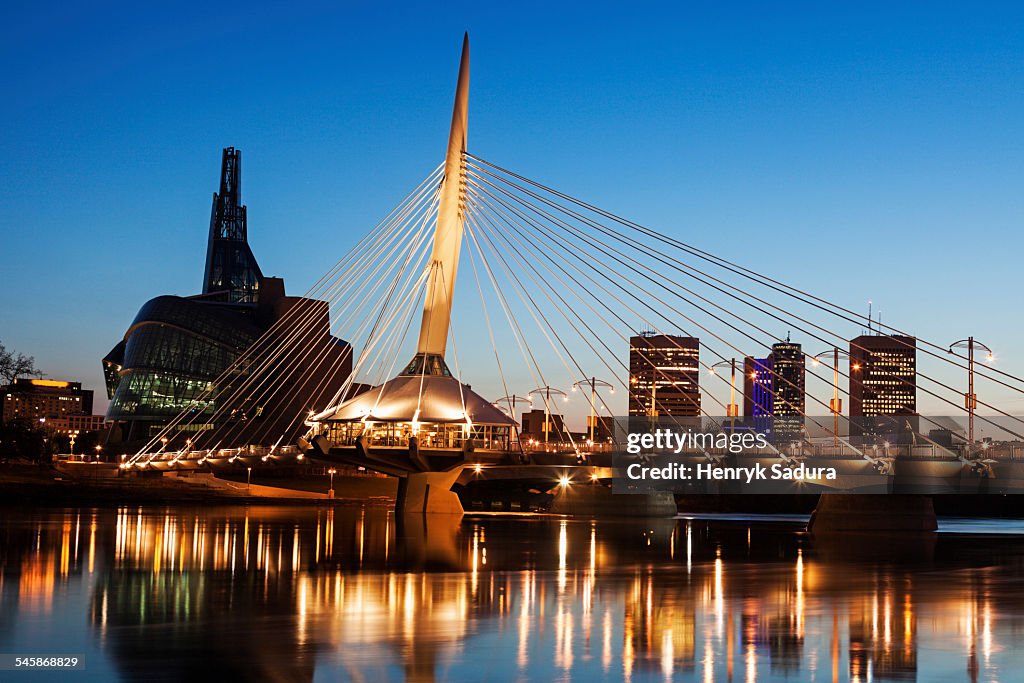 Canada, Manitoba, Winnipeg, Canadian Museum for Human Rights and Esplanade Riel bridge at dusk