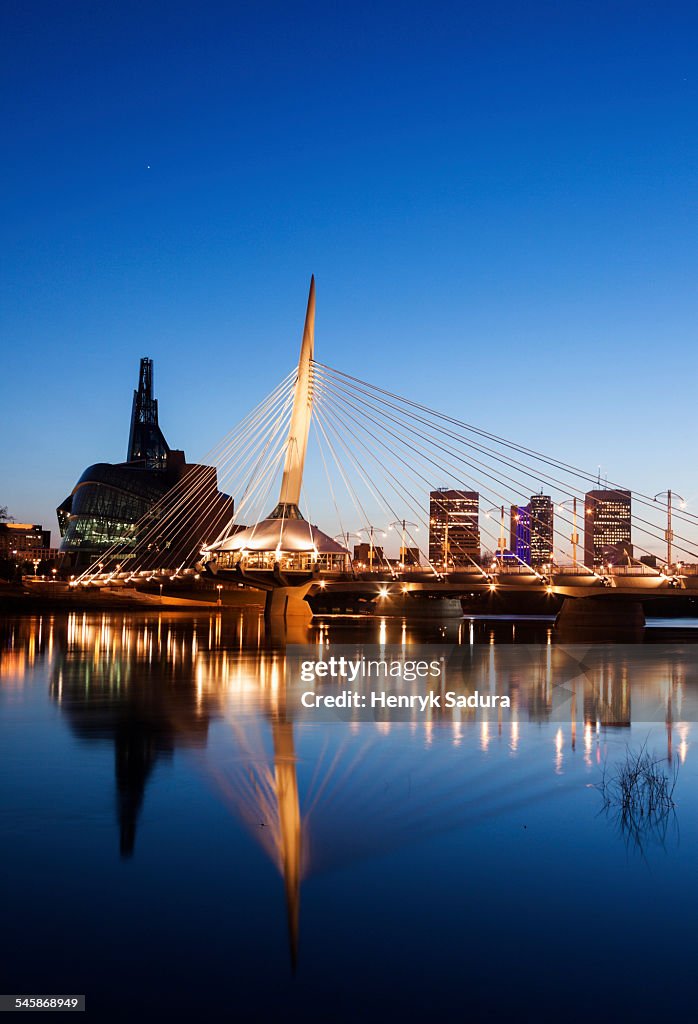 Canada, Manitoba, Winnipeg, Canadian Museum for Human Rights and Esplanade Riel bridge at dusk