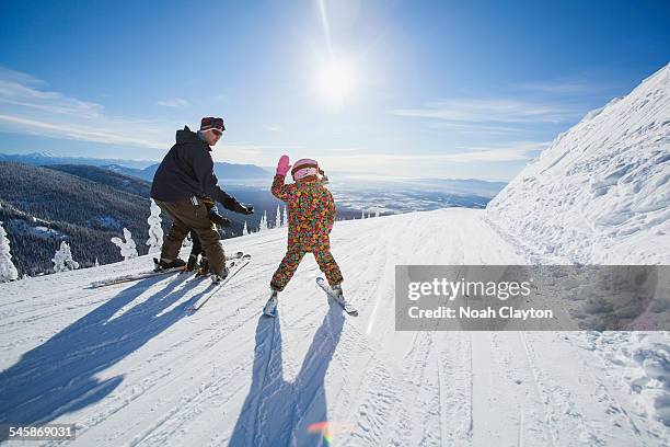 usa, montana, whitefish, father skiing with children (6-7, 8-9) - family skiing stock pictures, royalty-free photos & images