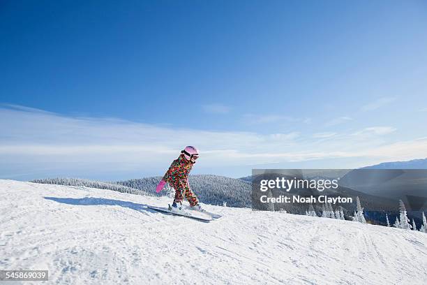 usa, montana, whitefish, girl (8-9) skiing in mountains - kids skiing stock pictures, royalty-free photos & images