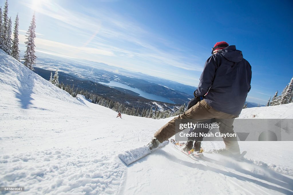 USA, Montana, Whitefish, Father skiing with son (6-7)