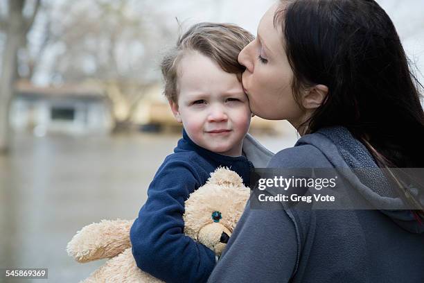 usa, illinois, mother with son standing in flooded town - home disaster fotografías e imágenes de stock