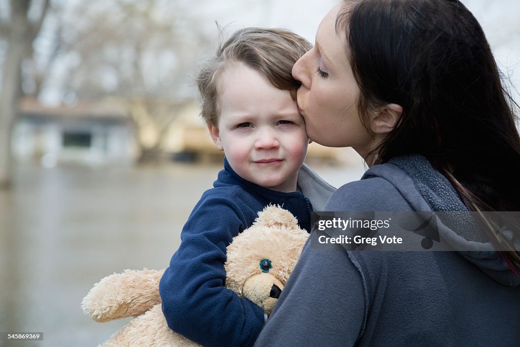 USA, Illinois, Mother with son standing in flooded town