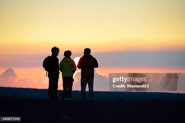 usa, hawaii, big island, volcanoes national park, three persons watching sunset at kilauea iki - watching sunrise stock pictures, royalty-free photos & images