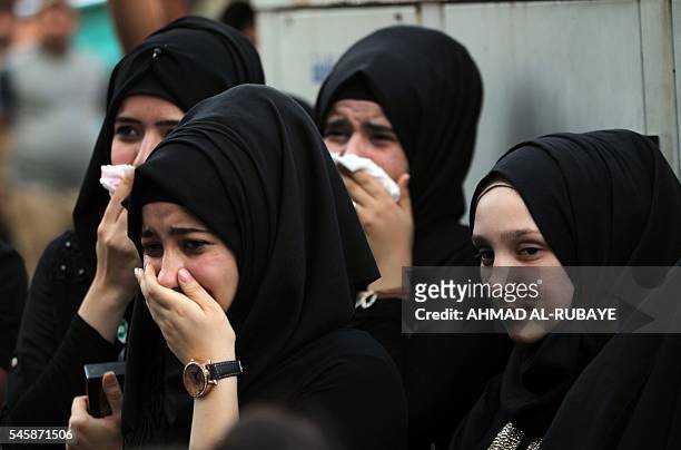 Iraqi women mourn at the site of the bombing in Baghdad's Karrada district during a symbolic funeral on July 10, 2016 for the victims of the attack....
