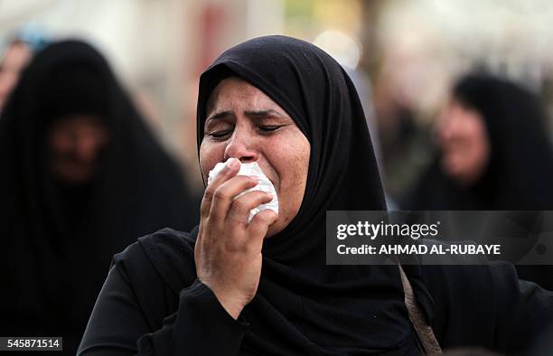 An Iraqi women mourns at the site of the bombing in Baghdad's Karrada district during a symbolic funeral on July 10, 2016 for the victims of the...