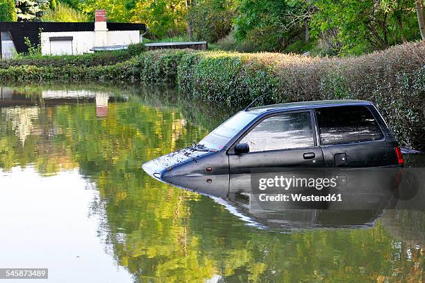 germany, saxony-anhalt, halle, garten, flood, sunken car and bungalow - germany flood stock pictures, royalty-free photos & images