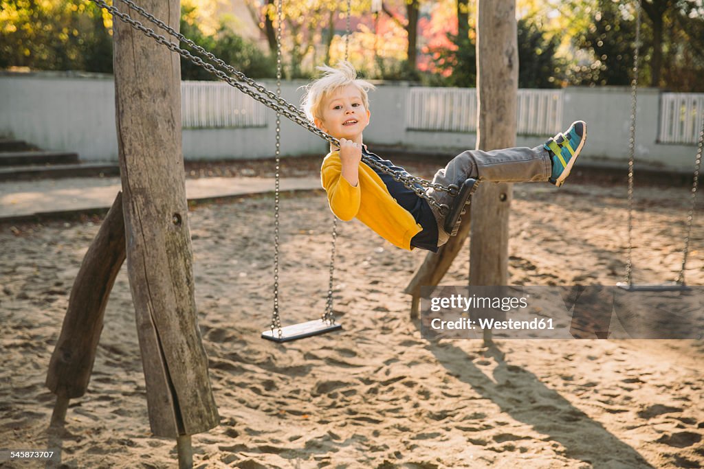 Toddler having fun on a swing