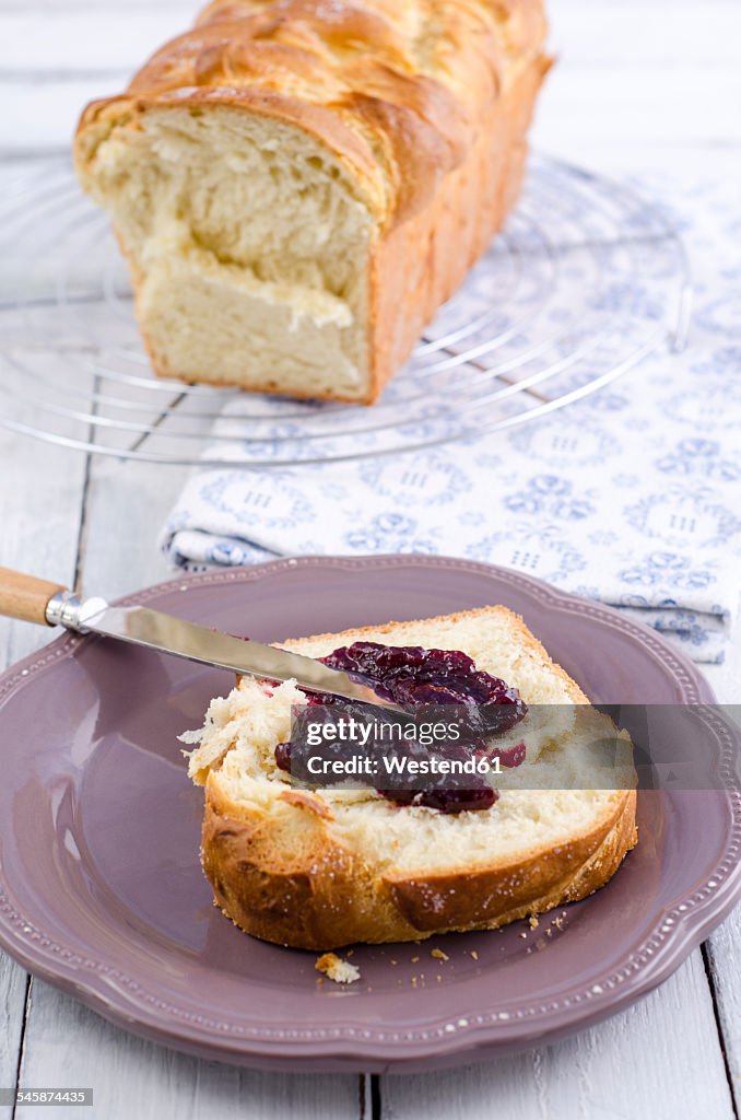 Slice of home-baked brioche spread with wild berry jam