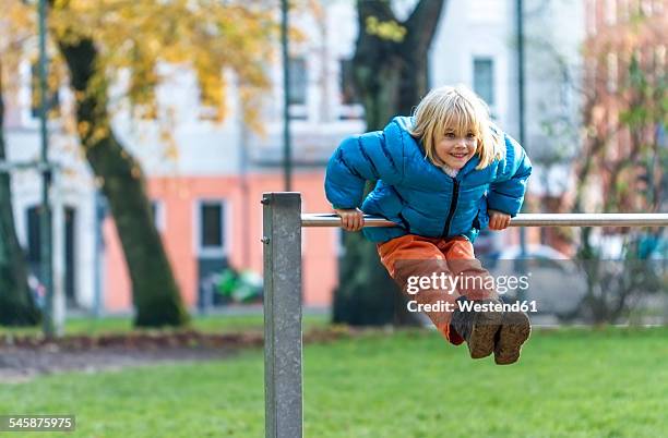 little girl doing gymnastics at high bar - horizontal bar stock pictures, royalty-free photos & images
