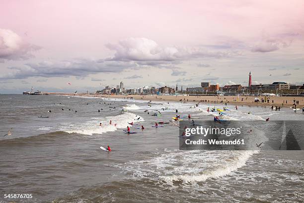 netherlands, the hague, scheveningen, beach and surfer in the evening light - scheveningen stock-fotos und bilder