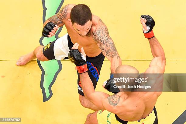 Frankie Edgar punches Jose Aldo of Brazil in their interim UFC featherweight championship bout during the UFC 200 event at T-Mobile Arena on July 9,...