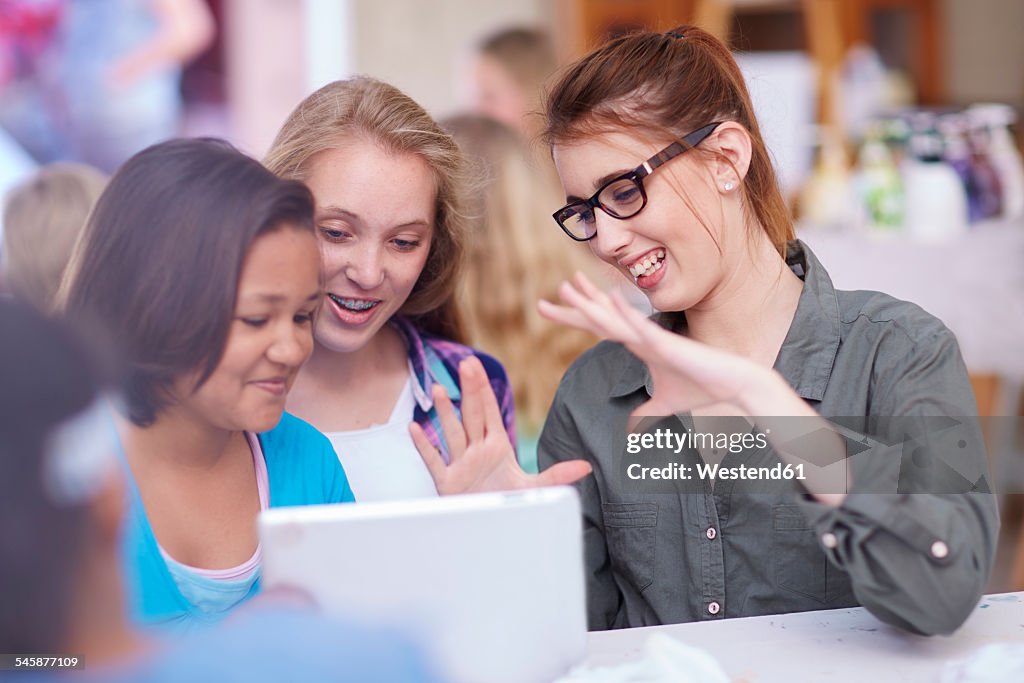 Teacher and schoolgirls with digital tablet