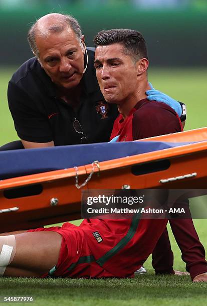 Cristiano Ronaldo of Portugal reacts to an injury during the UEFA Euro 2016 Final match between Portugal and France at Stade de France on July 10,...