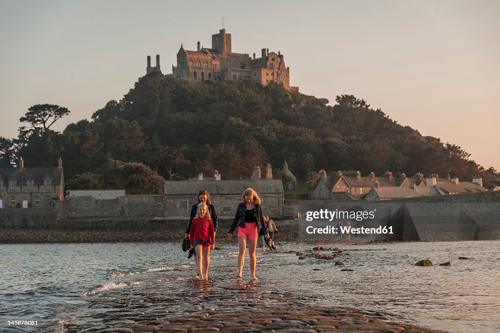 UK, England, Cornwall, family on causeway at tidal island St Michael's Mount