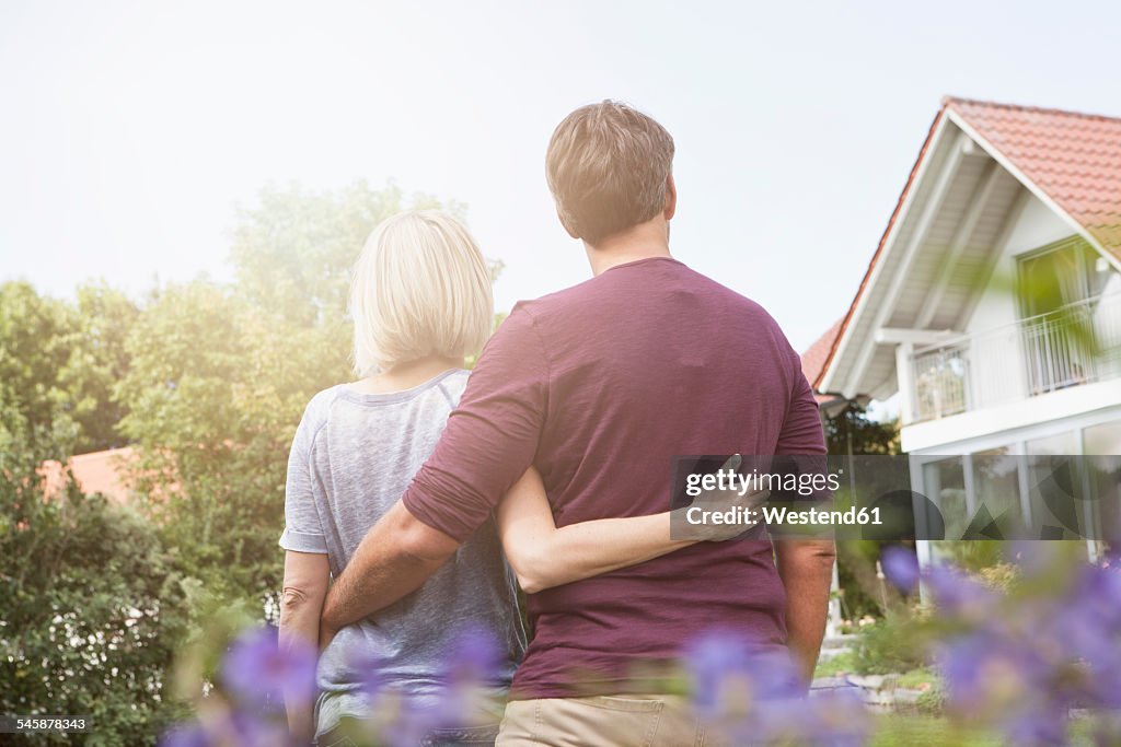 Rear view of mature couple in garden