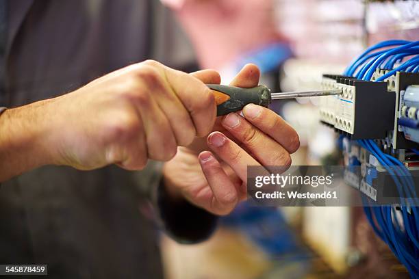 close-up of electrician working with screw driver - screwdriver stock pictures, royalty-free photos & images