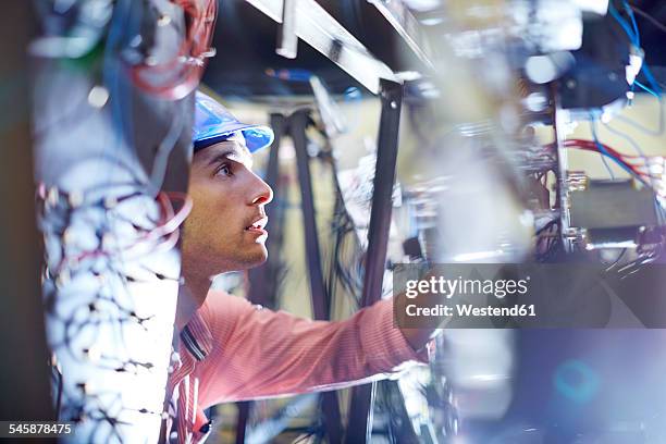 electrician testing wires - arbeiter baustelle stock-fotos und bilder