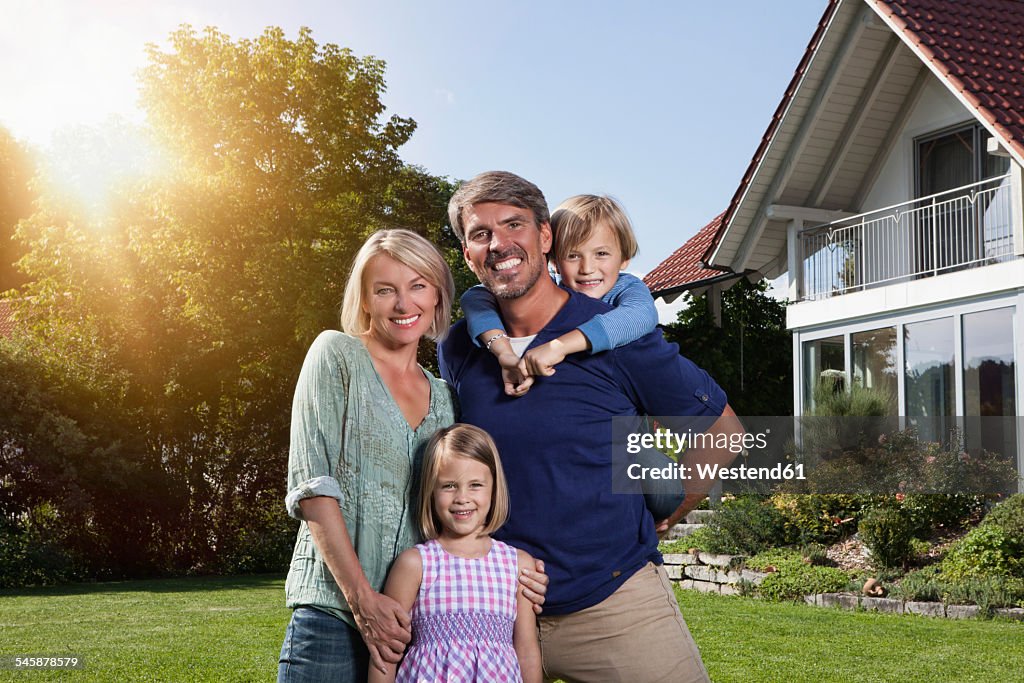 Portrait of happy family in garden