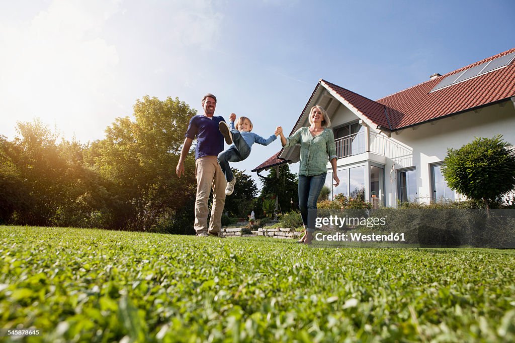 Happy family playing in garden