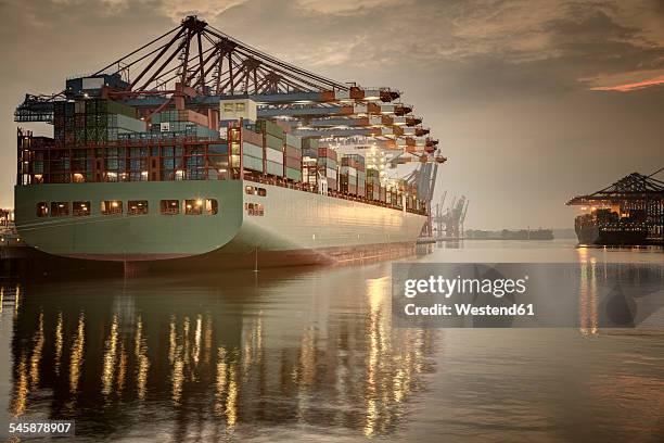 germany, hamburg, container terminal, container ship in the evening - containerschiffe stock-fotos und bilder