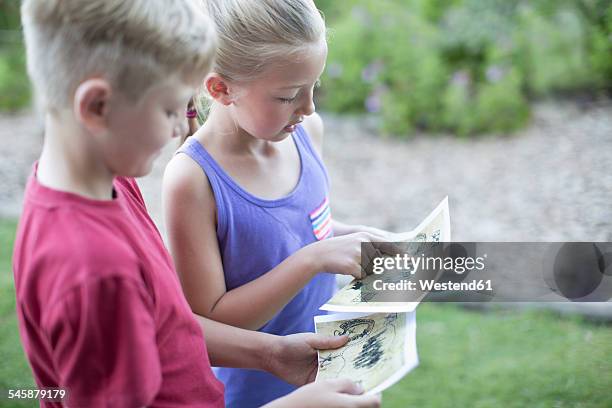 two kids on a treasure hunt - treasure hunt stock pictures, royalty-free photos & images