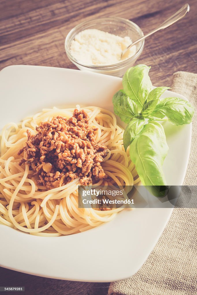 Spaghetti with bolognese sauce, basil and parmesan on plate