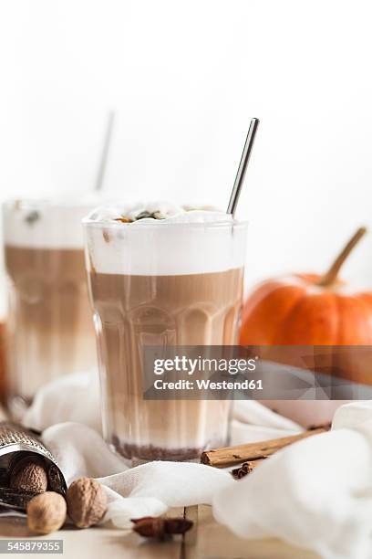 glass of pumpkin spice latte macchiato and spices on cloth - star anise stock pictures, royalty-free photos & images