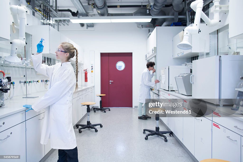 Two female scientists working in a pharmacy research laboratory