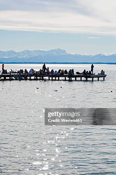 germany, bavaria, upper bavaria, starnberg, lake starnberg, people on jetty, bavarian alps and zugspitze in the background - starnberger see stock pictures, royalty-free photos & images