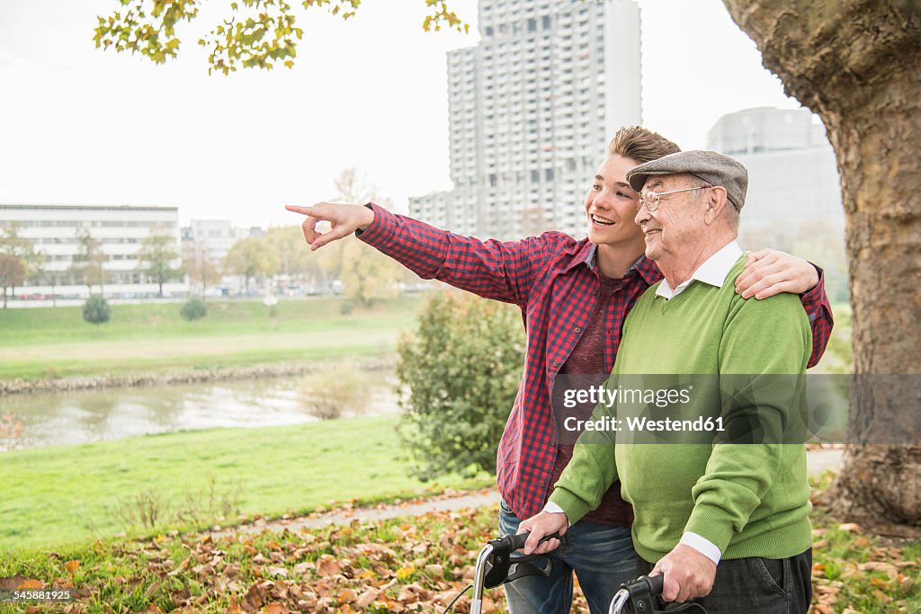 Senior man and adult grandson in park