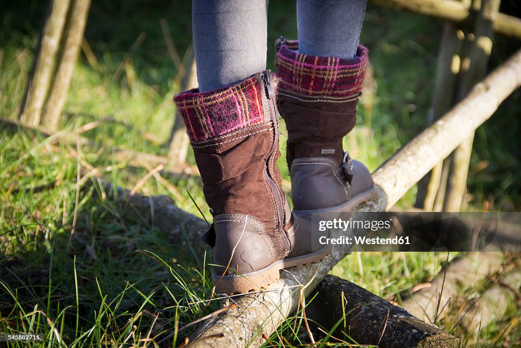 Germany, Bavaria, Landshut, girl balancing on log