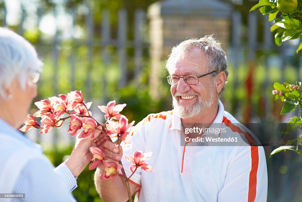 Senior couple with flower blossom in park