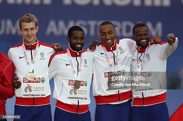 Jack Green, Delano Williams, Matthew Hudson-Smith, Rabah Yousif of Great Britain celebrate with their medals after winning bronze in the final of the...