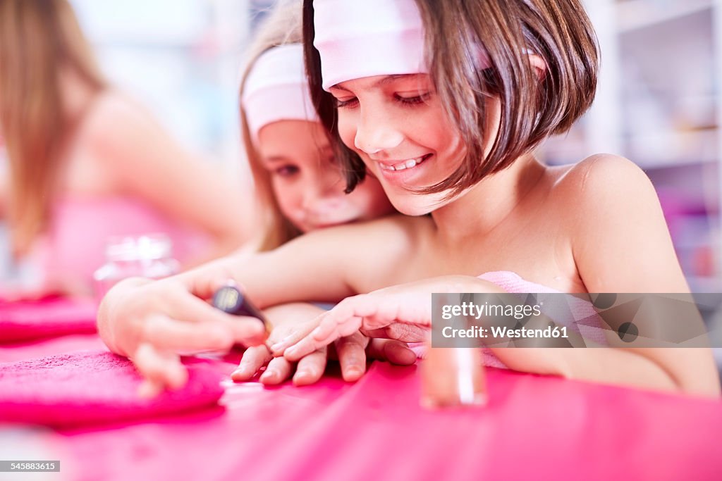 Girl on a beauty farm applying nail polish