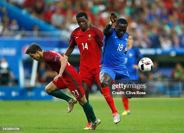 Cedric Soares and William Carvalho of Portugal combine to tackle Moussa Sissoko of France during the UEFA EURO 2016 Final match between Portugal and...