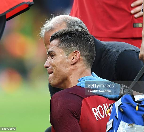 Cristiano Ronaldo of Portugal gets injured during the Euro 2016 final match between Portugal and France at Stade de France in Paris, France on July...