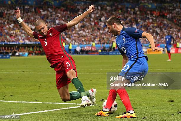 Andre Pierre Gignac of France is challenged by Pepe of Portugal during the UEFA Euro 2016 Final match between Portugal and France at Stade de France...