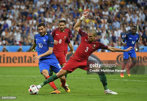 Pepe of Portugal and Andre-Pierre Gignac of France compete for the ball during the UEFA EURO 2016 Final match between Portugal and France at Stade de...