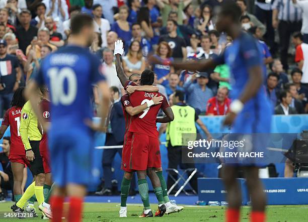 Portugal's forward Eder celebrates with Portugal's defender Pepe after scoring a goal during the Euro 2016 final football match between Portugal and...