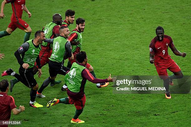 Portugal's forward Eder celebrates after scoring a goal with team mates during the Euro 2016 final football match between Portugal and France at the...