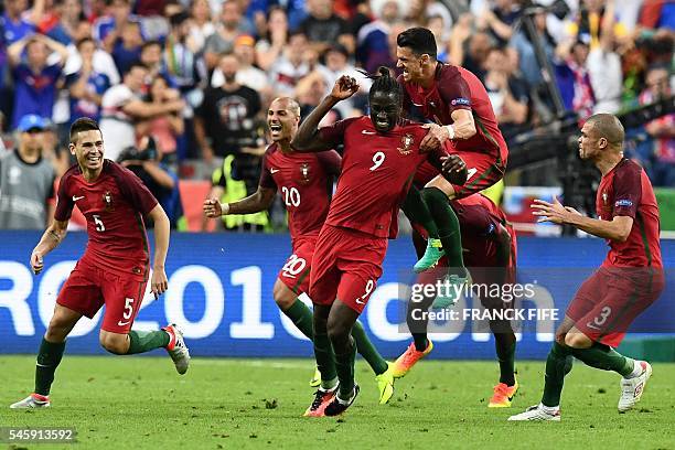 Portugal's forward Eder celebrates with Portugal's defender Pepe and Portugal's defender Raphael Guerreiro the team's first goal during the Euro 2016...