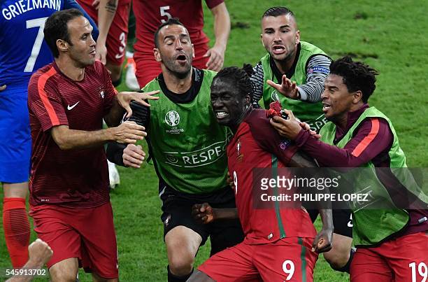 Portugal's forward Eder celebrates after scoring a goal with team mates during the Euro 2016 final football match between Portugal and France at the...