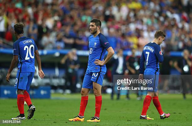 Kingsley Coman, Andre-Pierre Gignac and Antoine Griezmann of France show their dejection after Portugal's first goal during the UEFA EURO 2016 Final...