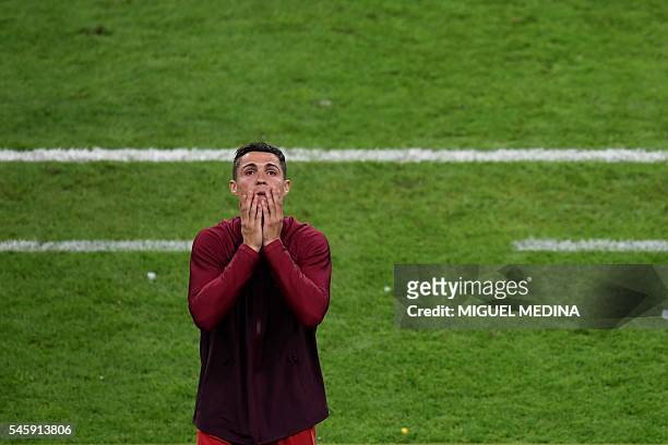 Portugal's forward Cristiano Ronaldo reacts during the Euro 2016 final football match between Portugal and France at the Stade de France in...