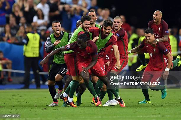 Portugal's forward Eder celebrates with teammates after he scored during the Euro 2016 final football match between Portugal and France at the Stade...