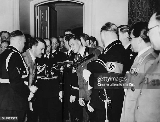 Germany, Flight captain Hans Baur presenting Adolf Hitler on the occasion of Hitler's 50th birthday the model of the new Heinkel aircraft, behind the...