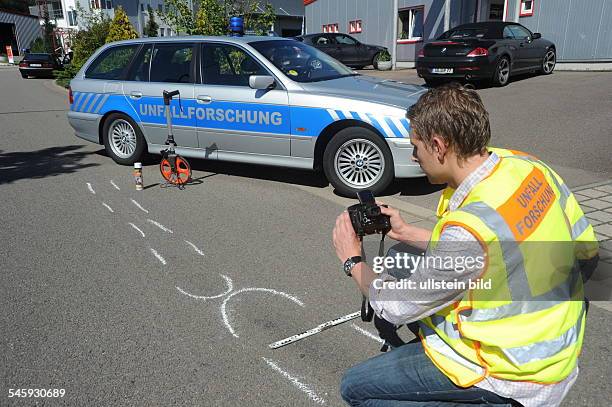 Germany Saarland Saarbruecken - accident research, accident investigator is checking skid marks -